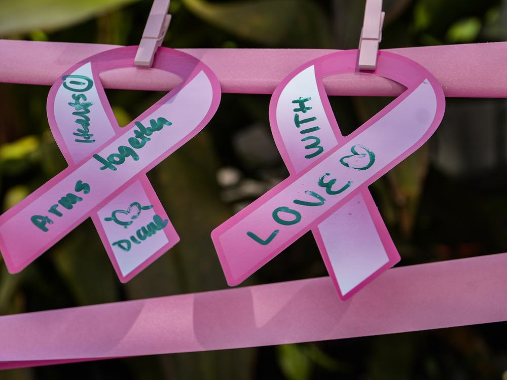 Two hand-written ribbons reading &lsquo;Arms together&rsquo; and &lsquo;With love&rsquo;.
