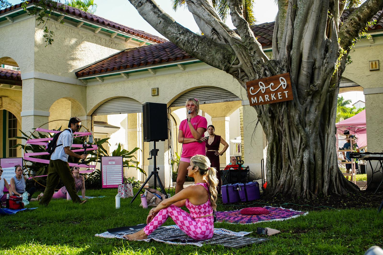 Coco Market Goes Pink at Old School Square - the market under the banyan tree, with the pink ribbon hoop set up on the grass.