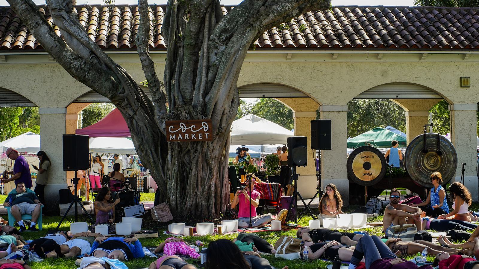 Sound healing at last year's Coco Market Goes Pink - crystal bowls and gongs under the banyan tree, with the crowd lying in savasana on the grass.