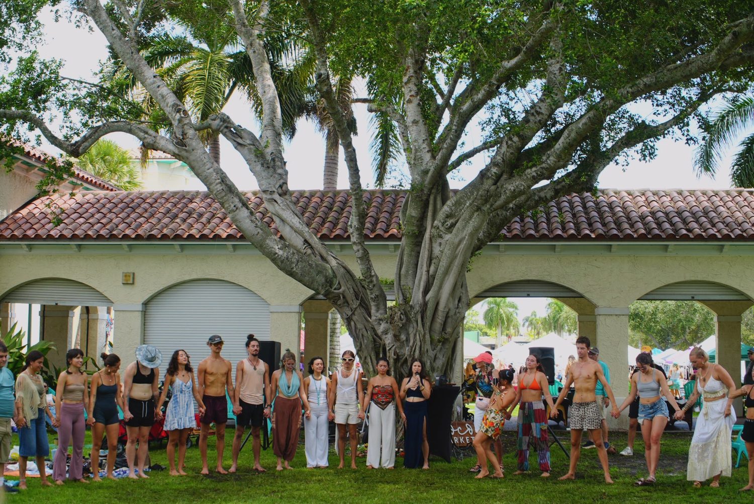 A circle of people in meditation with hands at heart